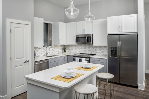 Modern kitchen featuring stainless steel appliances and granite countertops at Broadstone Trailside Apartments luxury complex
