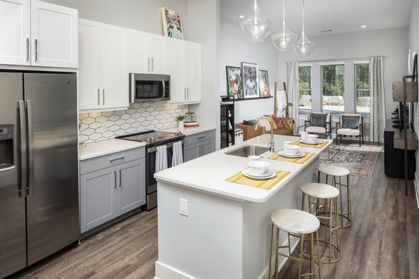 Modern kitchen with stainless steel appliances in Broadstone Trailside Apartments