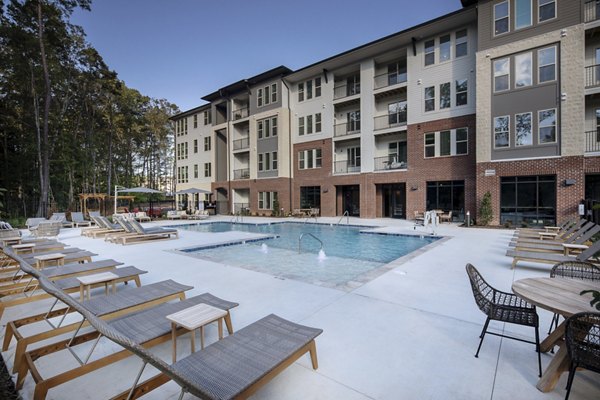 Rooftop pool with lounge chairs at Broadstone Trailside Apartments