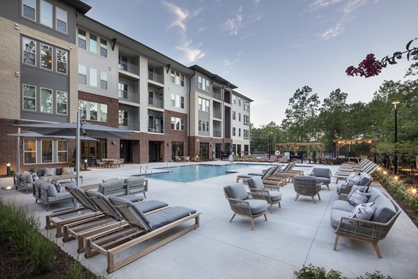 Outdoor pool with lounge chairs at Broadstone Trailside Apartments offering luxury living in scenic surroundings