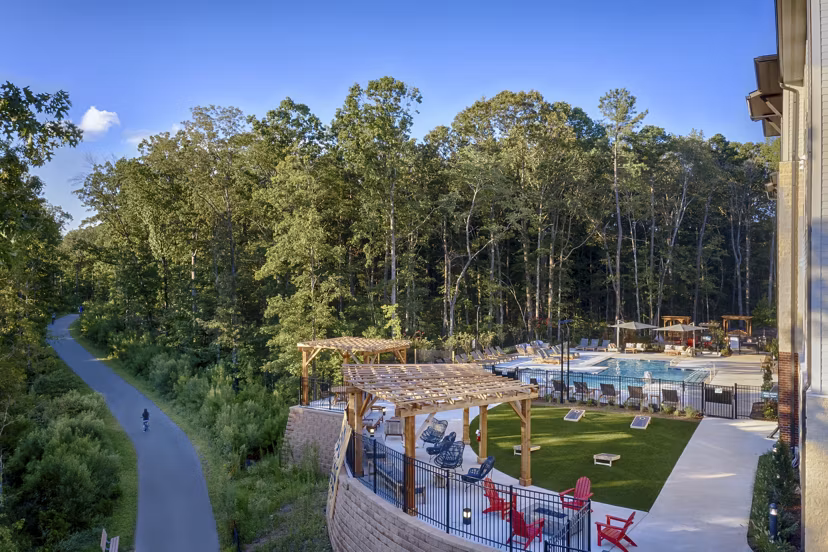 Modern swimming pool with lounge chairs at Broadstone Trailside Apartments, perfect for relaxation and leisure activities