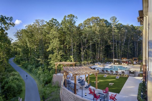 Modern swimming pool with lounge chairs at Broadstone Trailside Apartments, perfect for relaxation and leisure activities