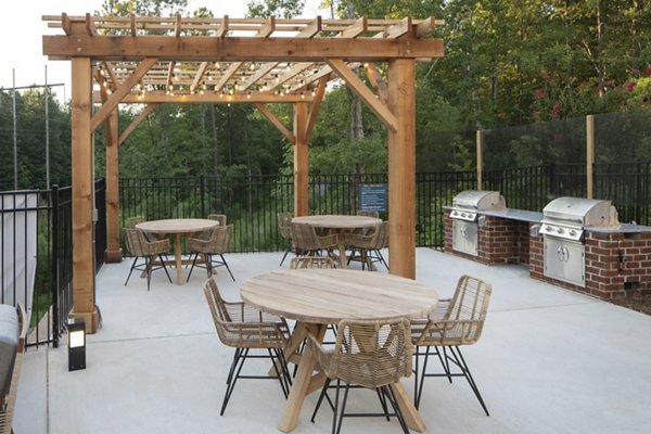Outdoor grill area with modern seating at Broadstone Trailside Apartments