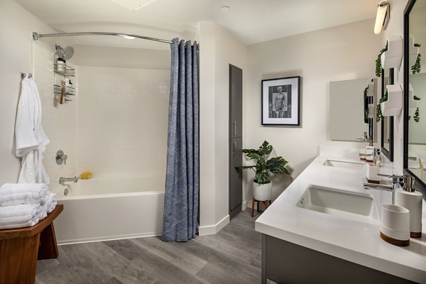 Bathroom featuring sleek countertops and modern fixtures in Garrison Apartments luxury community