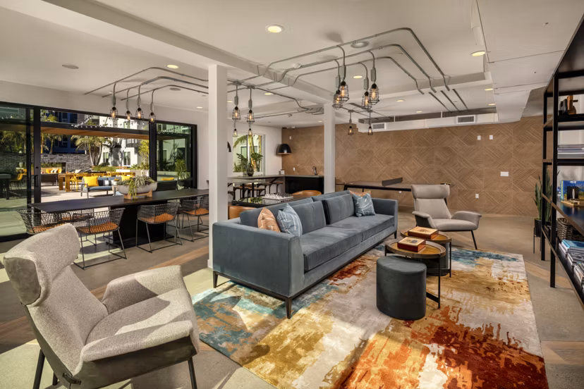 Clubhouse at Garrison Apartments: Elegant community space with contemporary design and cozy seating for residents to enjoy leisure and gatherings