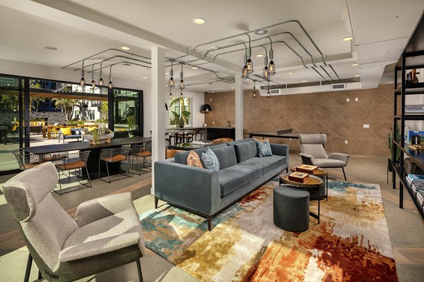 Clubhouse at Garrison Apartments: Elegant community space with contemporary design and cozy seating for residents to enjoy leisure and gatherings