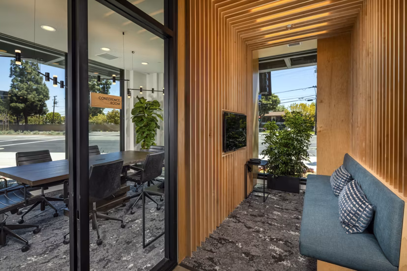 Clubhouse with modern design and cozy seating at Garrison Apartments, offering a welcoming space for residents