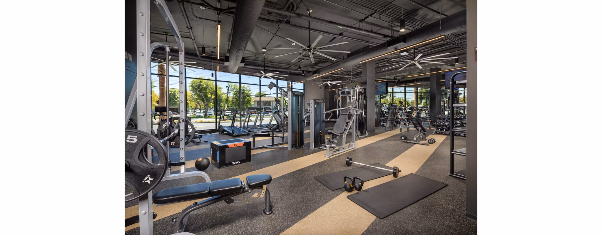 State-of-the-art fitness center with modern equipment at Garrison Apartments for resident wellness and exercise