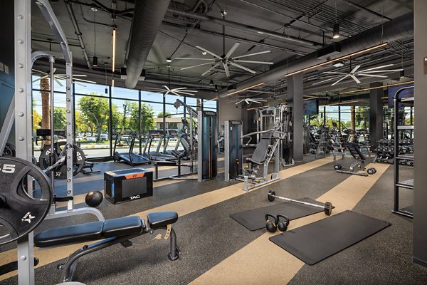 State-of-the-art fitness center with modern equipment at Garrison Apartments for resident wellness and exercise