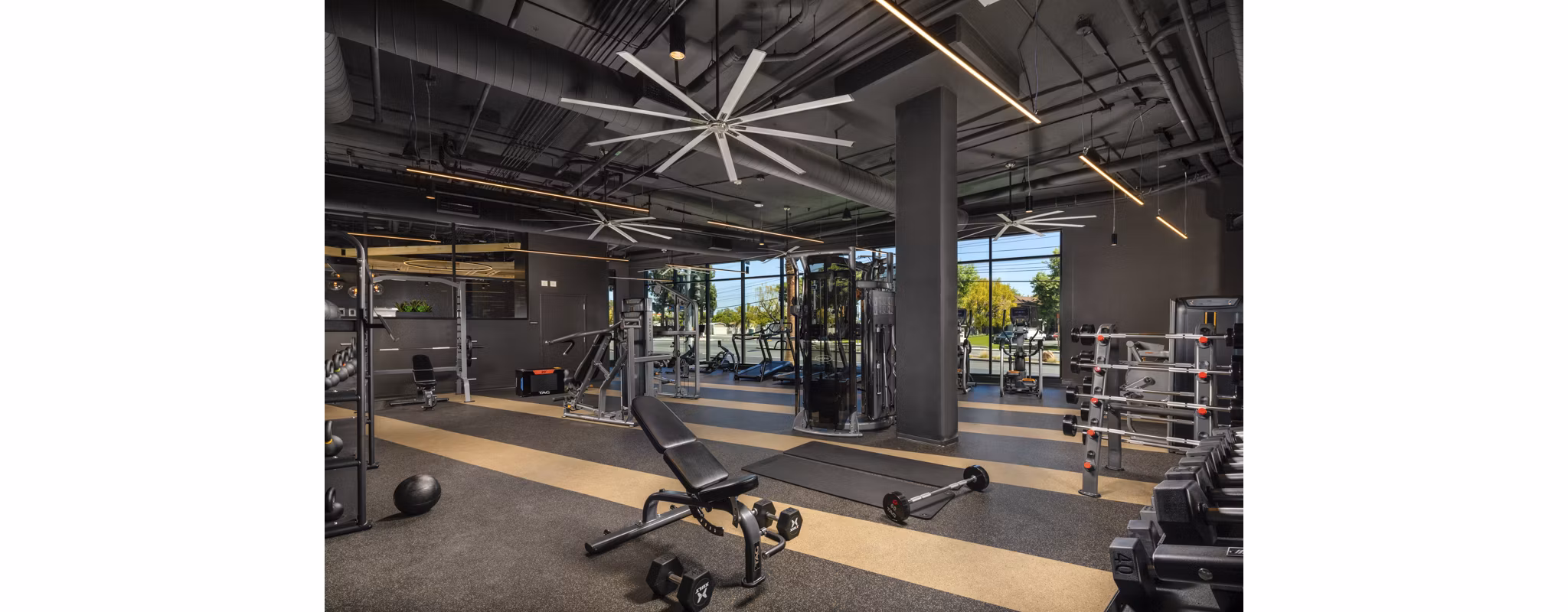 Fitness center featuring modern exercise equipment at Garrison Apartments, offering residents a comprehensive workout experience