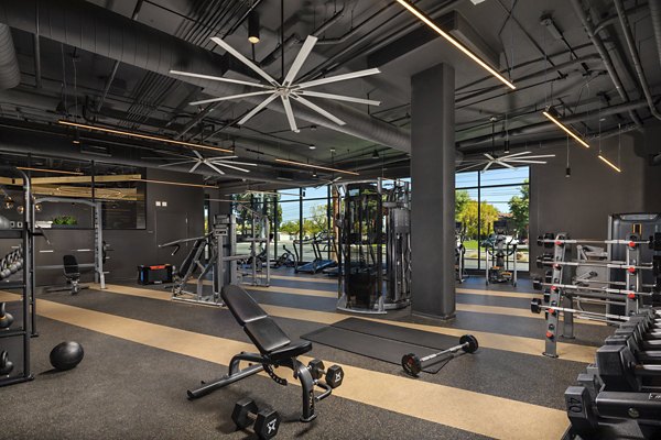 Fitness center featuring modern exercise equipment at Garrison Apartments, offering residents a comprehensive workout experience