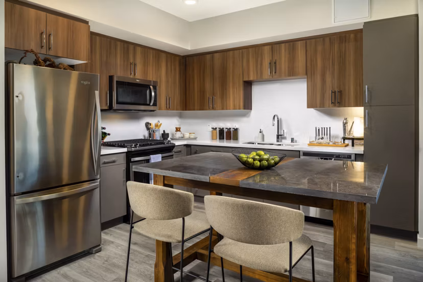 Modern kitchen with stainless steel appliances in Garrison Apartments: Luxury living by Greystar