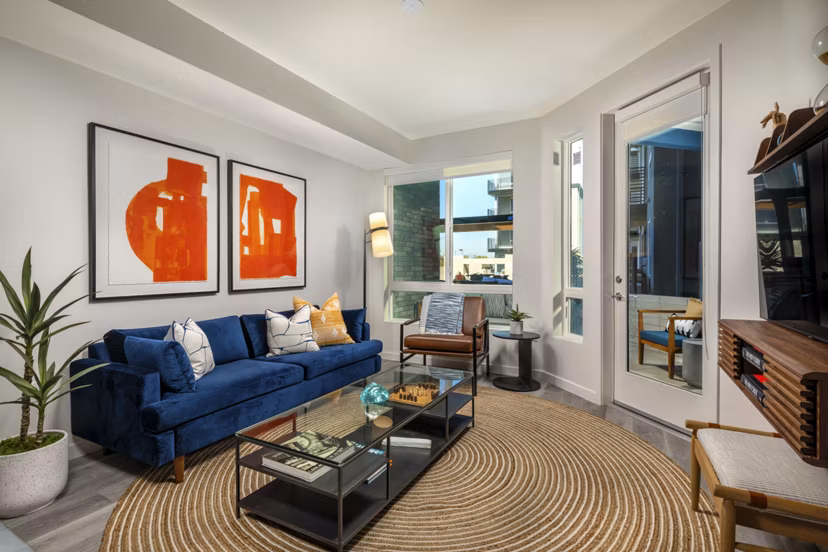 Spacious living room with modern decor and natural light in Garrison Apartments