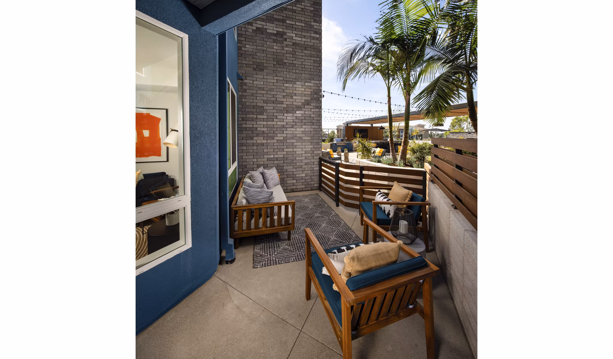 Inviting patio space at Garrison Apartments with modern seating and lush greenery