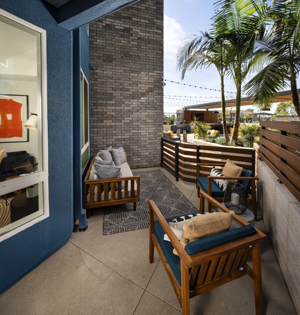 Inviting patio space at Garrison Apartments with modern seating and lush greenery