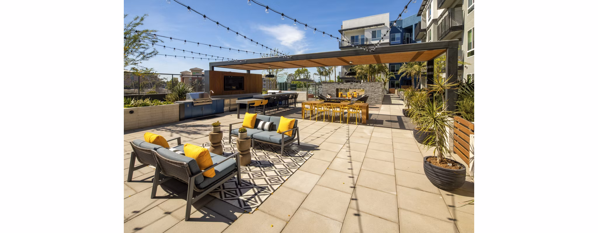 Courtyard with lush greenery and seating at Garrison Apartments, showcasing a serene outdoor retreat for relaxation