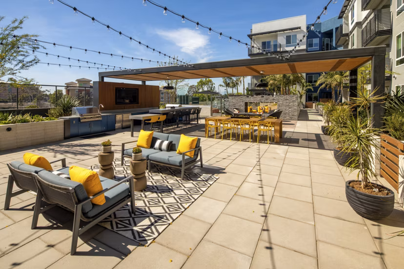 Courtyard with lush greenery and seating at Garrison Apartments, showcasing a serene outdoor retreat for relaxation