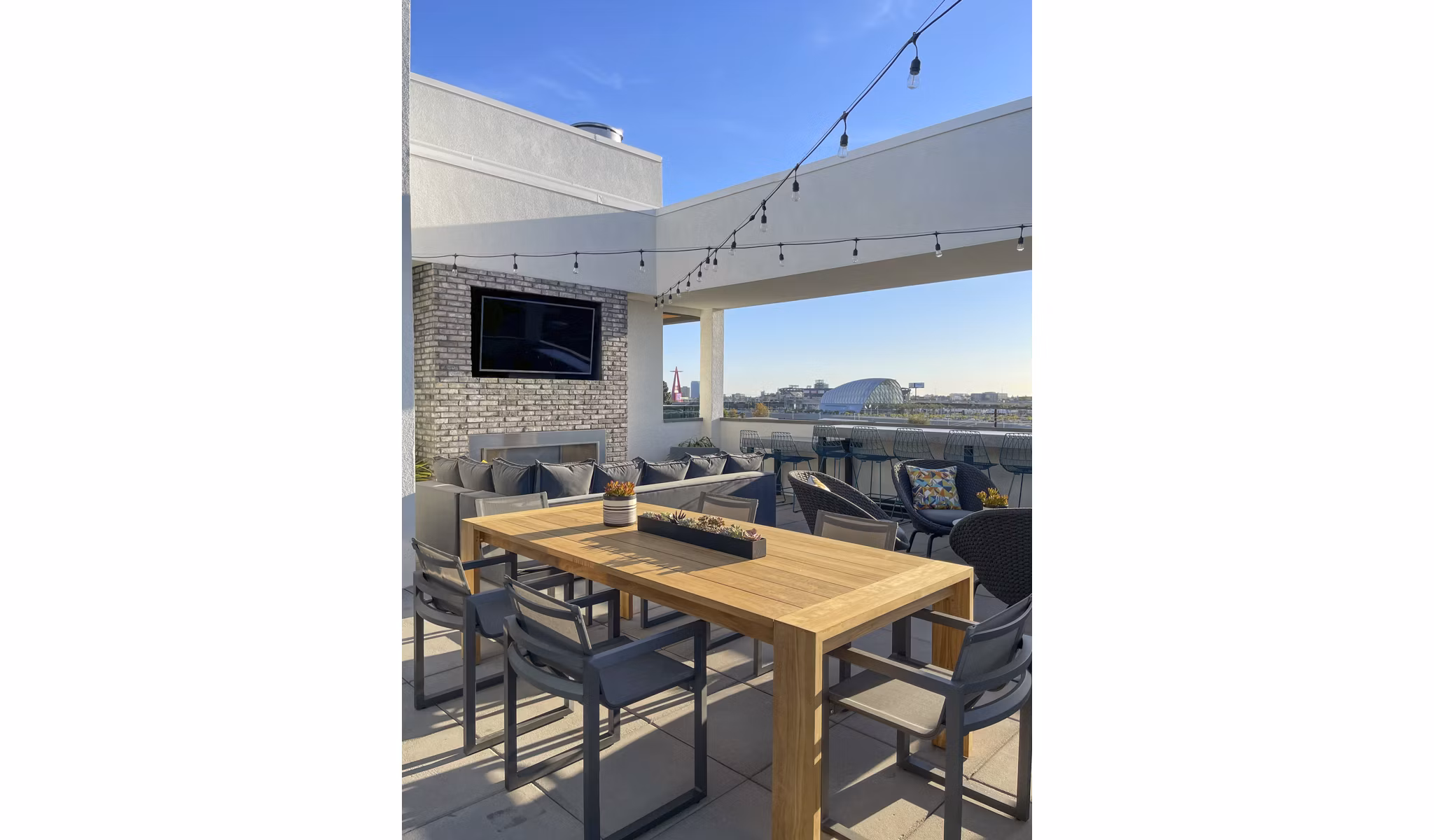 Rooftop deck with modern outdoor seating at Garrison Apartments luxury complex in urban landscape