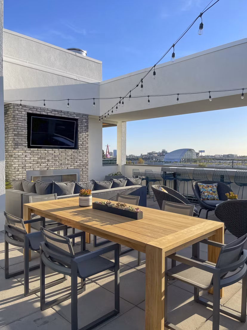 Rooftop deck with modern outdoor seating at Garrison Apartments luxury complex in urban landscape