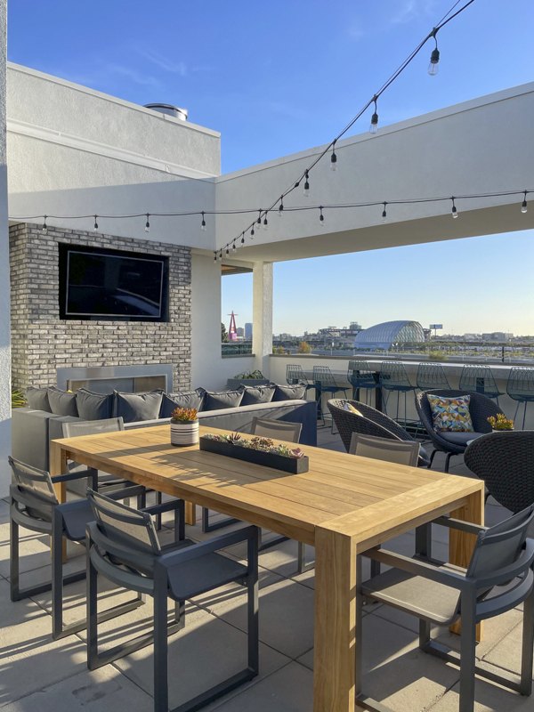 Rooftop deck with modern outdoor seating at Garrison Apartments luxury complex in urban landscape