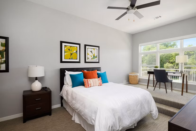 Cozy bedroom with plush bedding and modern decor at Brookside 51 Apartments