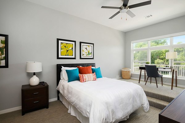 Cozy bedroom with plush bedding and modern decor at Brookside 51 Apartments