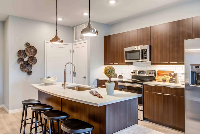 Modern kitchen with stainless steel appliances in Brookside 51 Apartments
