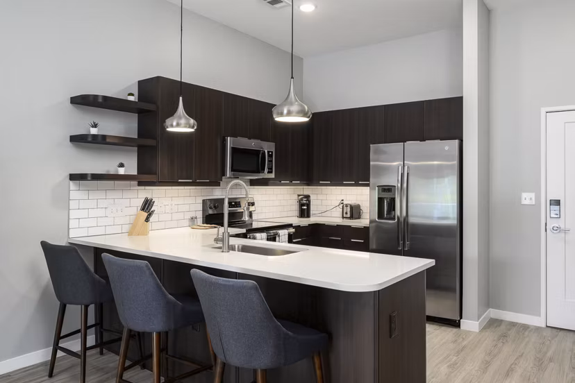 Modern kitchen with stainless steel appliances at Brookside 51 Apartments