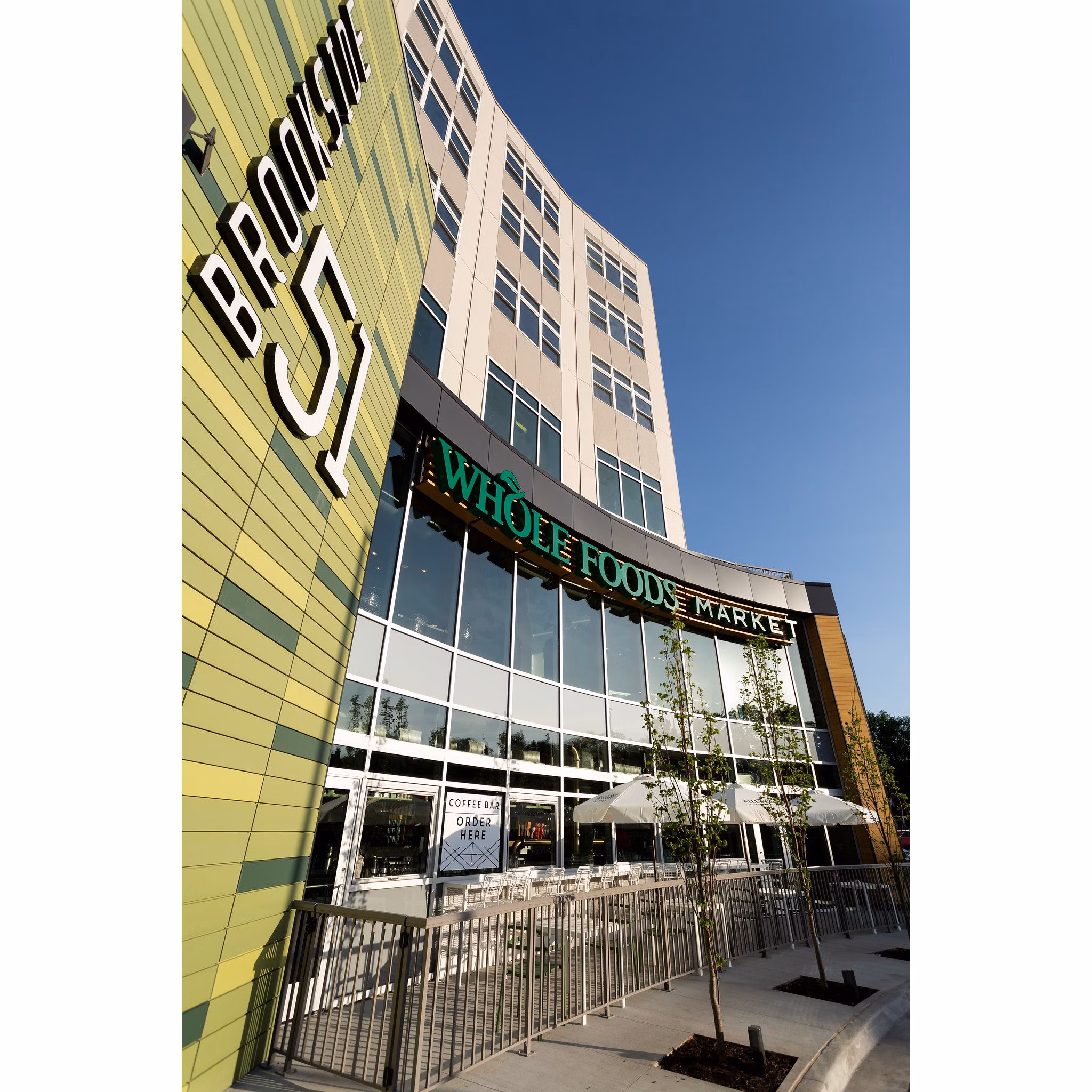 Charming neighborhood view at Brookside 51 Apartments featuring tree-lined streets and modern architecture