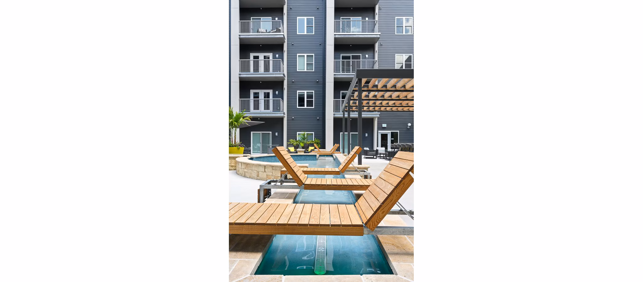 Modern outdoor pool with sun loungers at Brookside 51 Apartments, offering relaxation and recreation options within a premier community