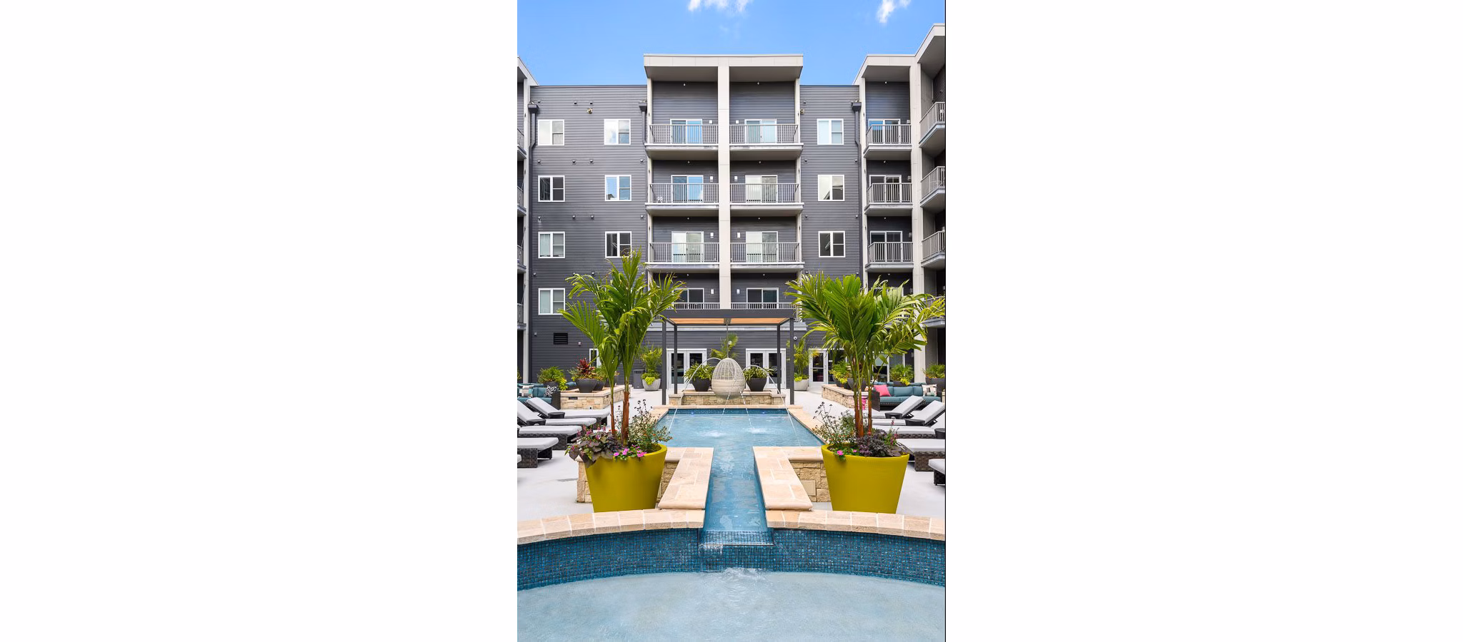 Refreshing outdoor pool at Brookside 51 Apartments offering a relaxing oasis with sun loungers and greenery