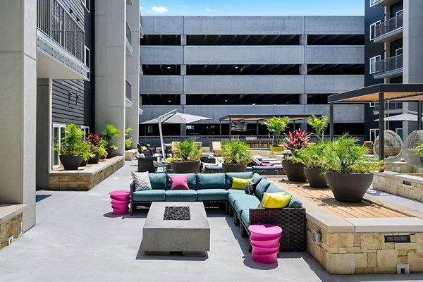 Outdoor fire pit with cozy seating area at Brookside 51 Apartments, perfect for gatherings and relaxation in a luxurious setting