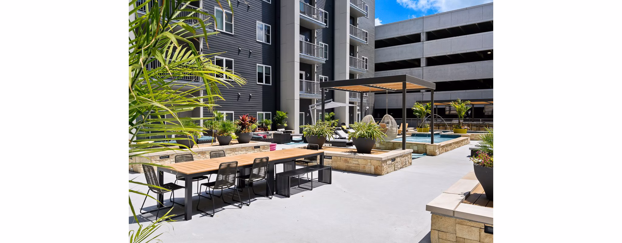 Serene courtyard with lush greenery at Brookside 51 Apartments, a luxury community offering modern living spaces and exclusive amenities