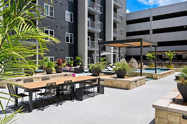 Serene courtyard with lush greenery at Brookside 51 Apartments, a luxury community offering modern living spaces and exclusive amenities