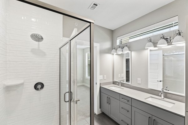 Bathroom featuring sleek fixtures and modern design at The Jameson at the Bluffs Apartments