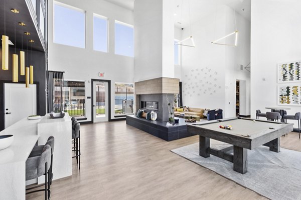 Clubhouse featuring modern design and spacious lounge areas at The Jameson at the Bluffs Apartments