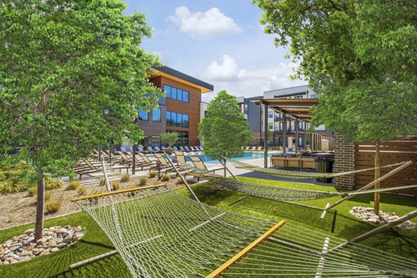 Courtyard with modern seating and garden views at The Jameson at the Bluffs Apartments