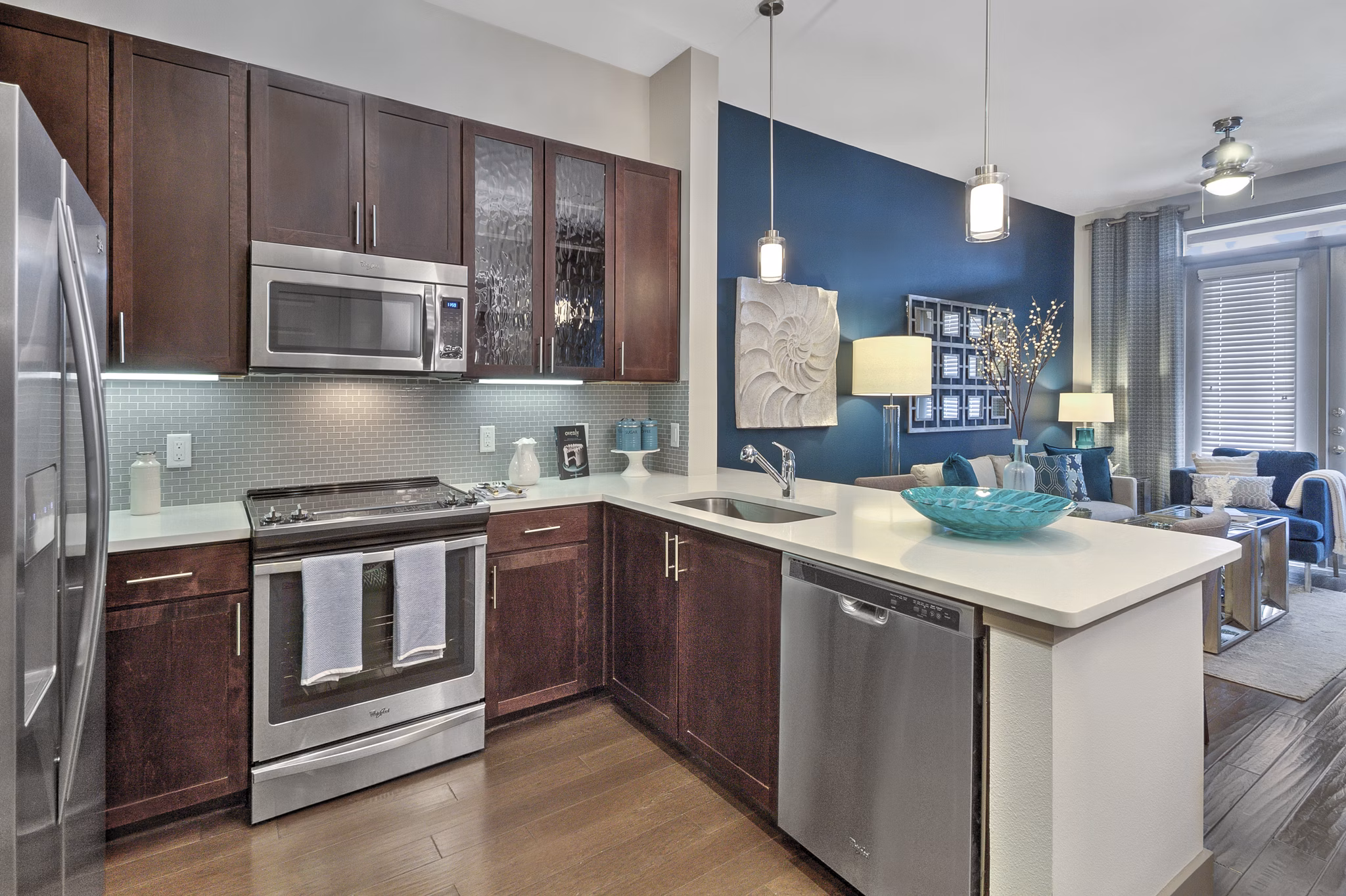 Modern kitchen with stainless steel appliances in Circuit Apartments