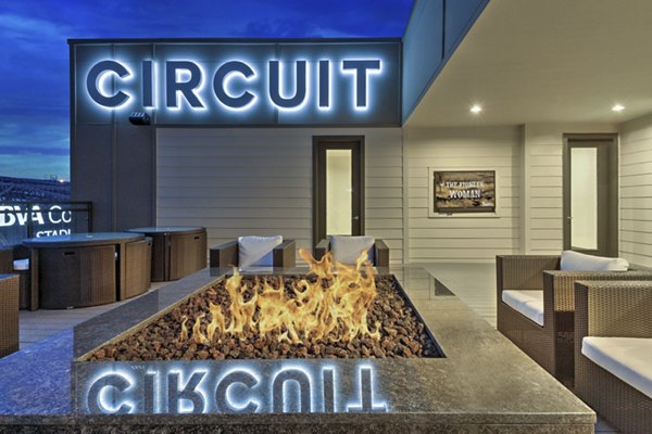 Inviting fire pit surrounded by cozy seating at Circuit Apartments