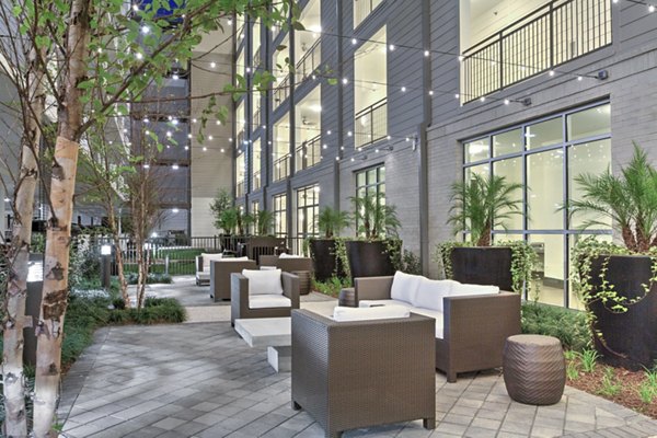 Outdoor patio with stylish seating at Circuit Apartments, perfect for relaxation and socializing in a contemporary urban setting