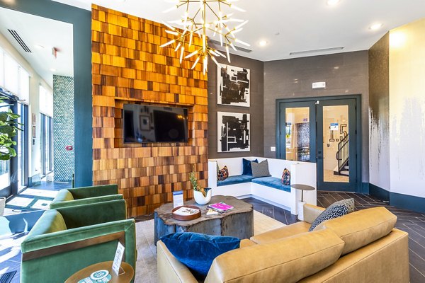 Modern clubhouse lobby with stylish seating at Foundry on 19th Apartments, offering a welcoming atmosphere and community space