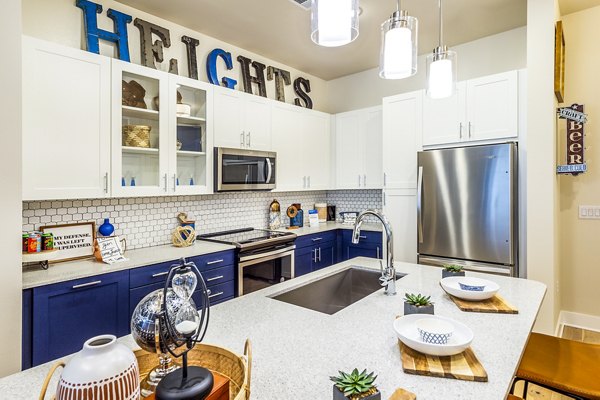 Modern kitchen featuring sleek cabinetry and stainless appliances in Foundry on 19th Apartments