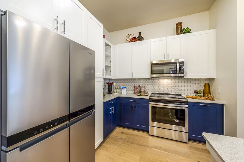 Modern kitchen with stainless steel appliances at Foundry on 19th Apartments