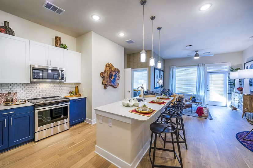 Kitchen featuring modern appliances and sleek cabinetry at Foundry on 19th Apartments