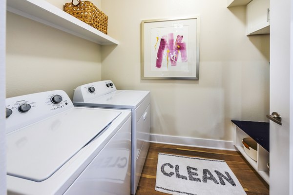Modern laundry room with energy-efficient machines at Foundry on 19th Apartments