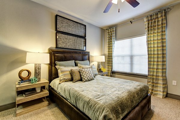 Spacious bedroom featuring modern decor at The Manor at Weston Apartments, a luxury community by Greystar