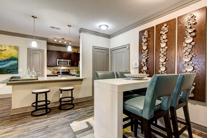 Dining area with elegant furniture and modern lighting at The Manor at Weston Apartments