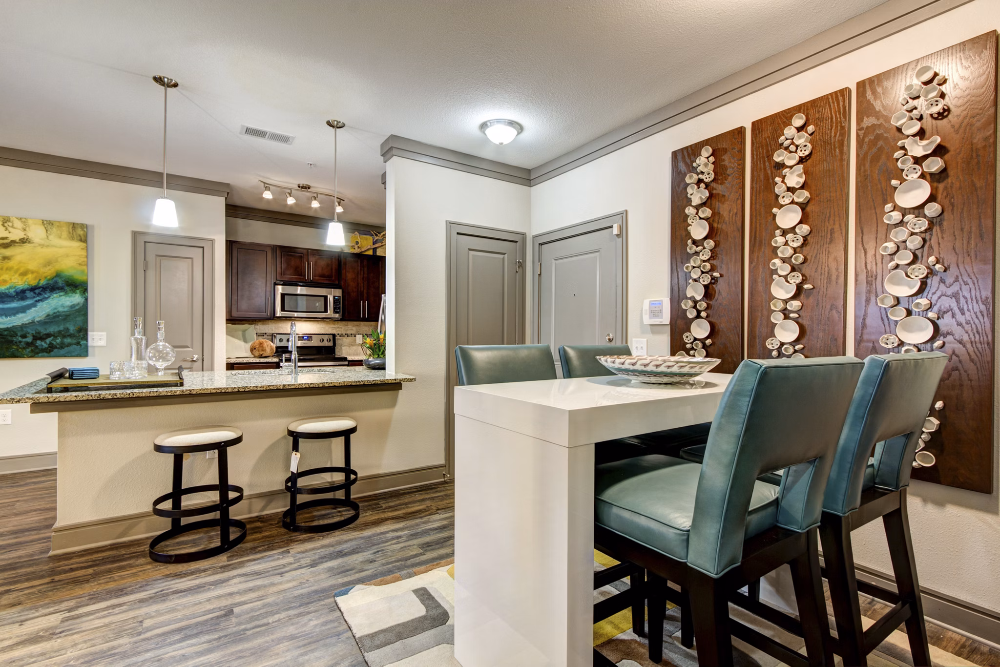 Dining area with elegant furniture and modern lighting at The Manor at Weston Apartments