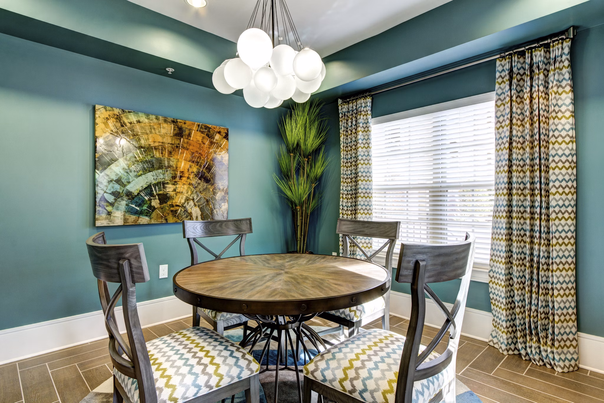 Dining area featuring elegant lighting and modern furnishings at The Manor at Weston Apartments in the Greystar luxury community