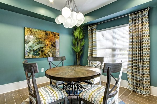 Dining area featuring elegant lighting and modern furnishings at The Manor at Weston Apartments in the Greystar luxury community